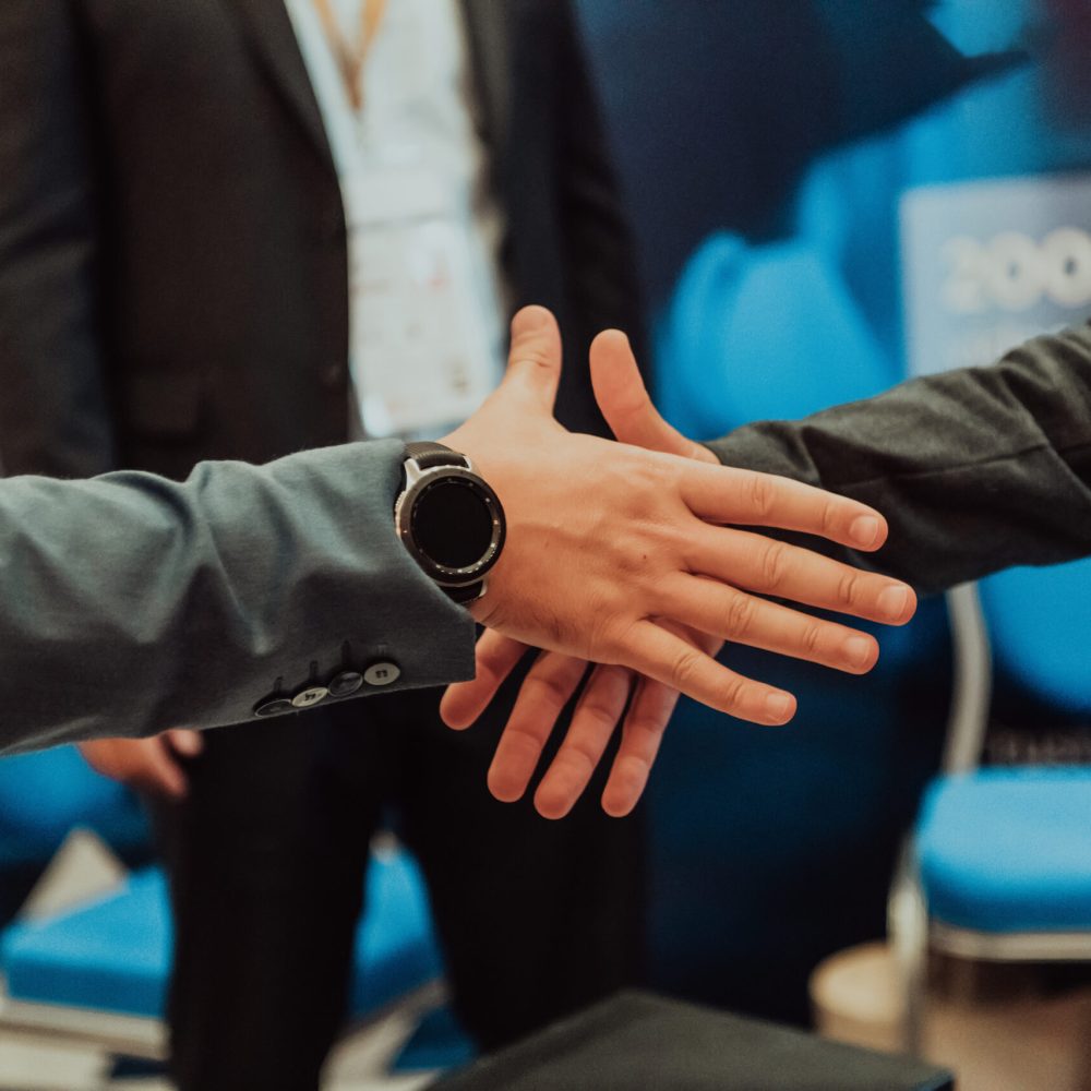 Close up a handshake, businessman together creates a mutually beneficial business relationship. The economic graph on the table.